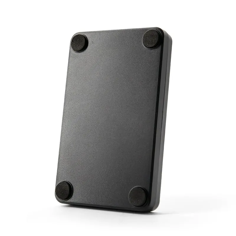 A140-U FDX-B desktop reader underside with four rubber feet, angled view