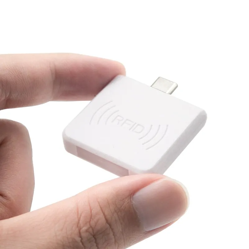 White L220-C RFID reader held between two fingers to show its size